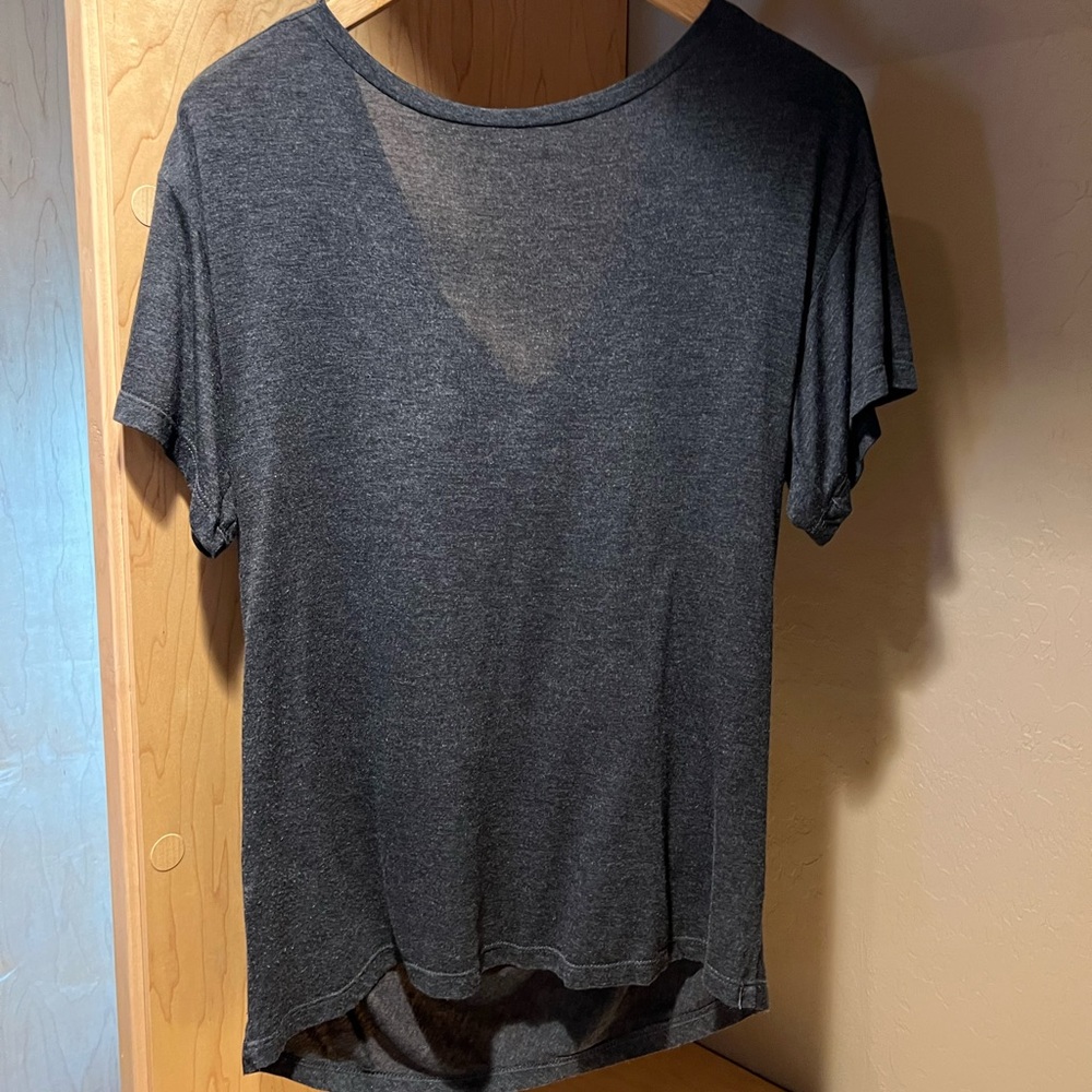 Heather,M, charcoal grey, short sleeve, serious in the front party in the back